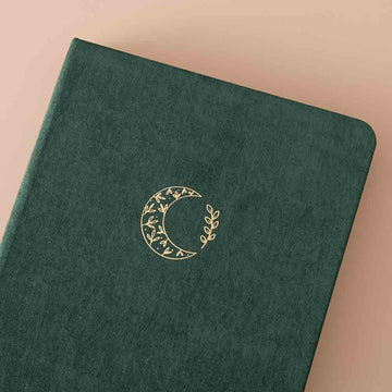 Close up of the front cover of Tsuki ‘Midnight Garden’ Limited Edition Bullet Journal on beige background